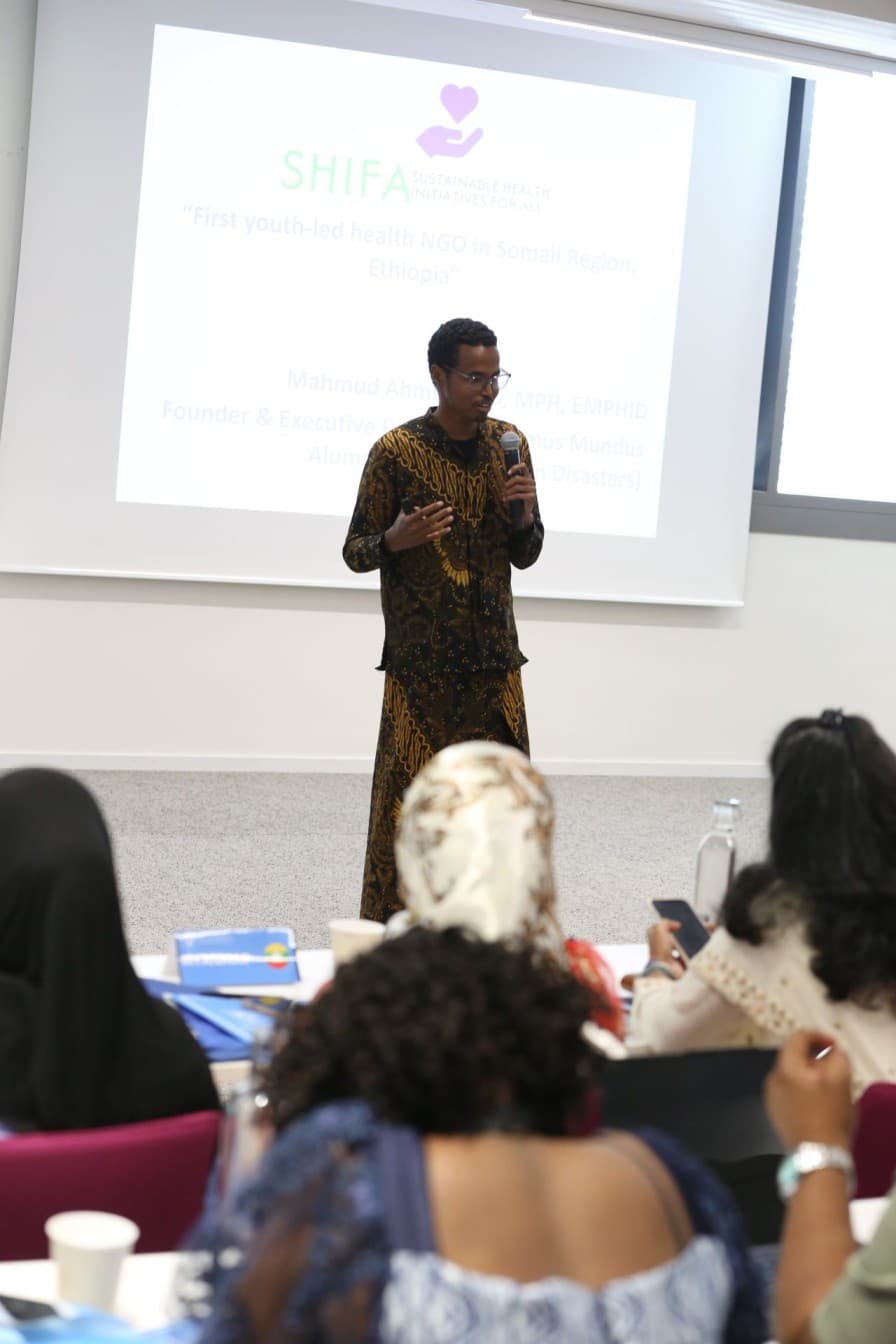 SHIFA's Founder and Executive Director, Mahmud Ahmed, presenting on stage at the Youth Empowerment Forum 2025 in Geneva, Switzerland